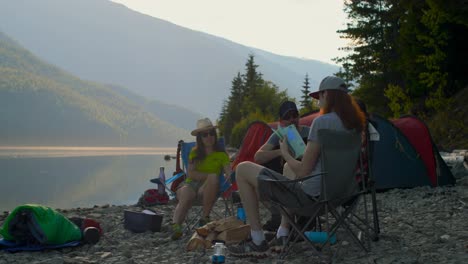 group of hikers camping near riverside 4k