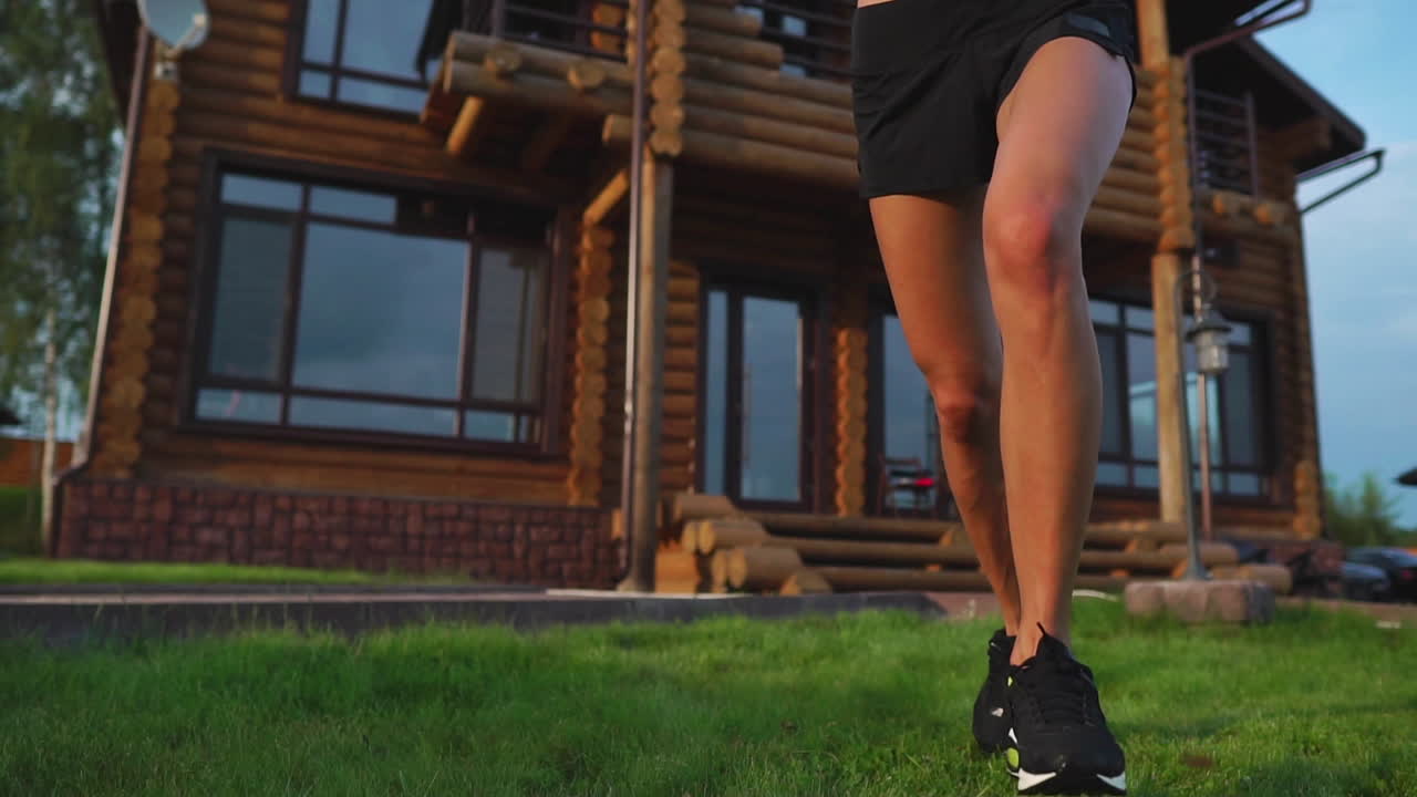 Girl running in the Park at sunset near his house