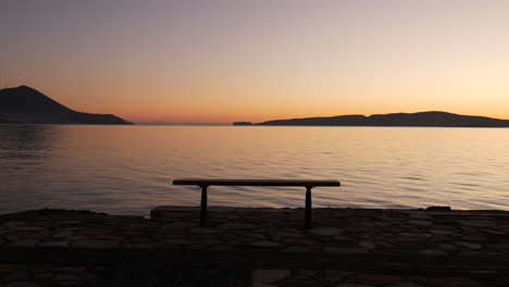 epic shot of an empty bench with a golden sunset view