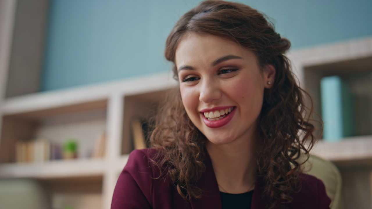 Cheerful lady talking web conference in office closeup. Happy executive calling