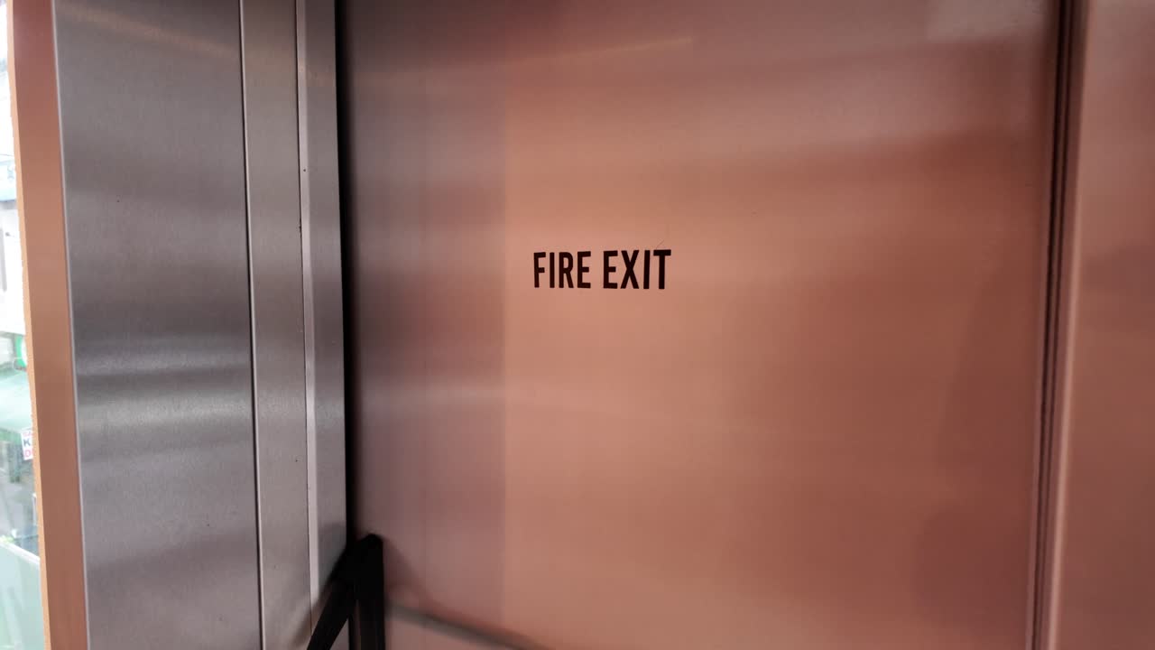 Metallic Fire Exit Door with Sign in a Building