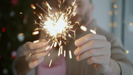 couple celebrating new year's eve with sparklers