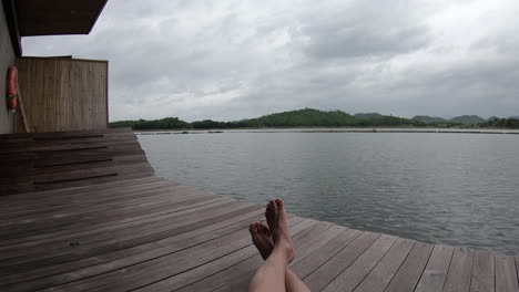 feet-relaxing-with-lake-and-hill-background