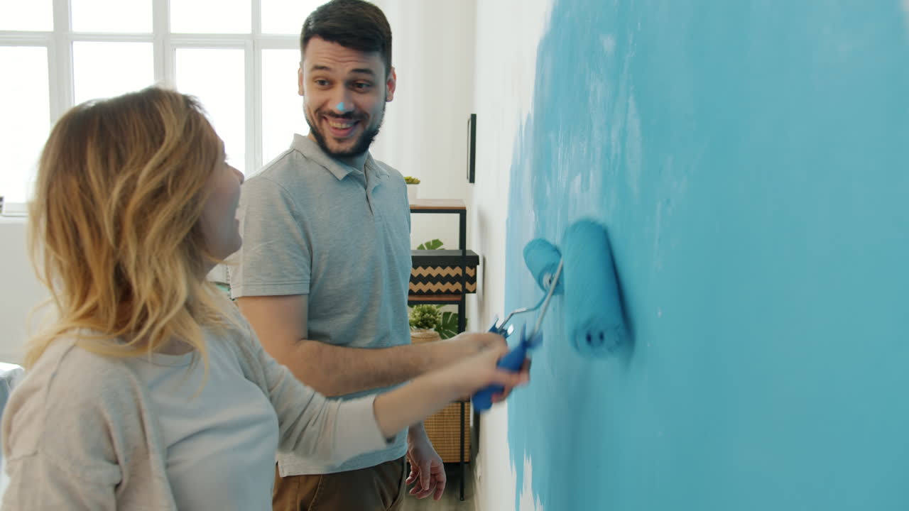 Couple Painting a Wall Blue