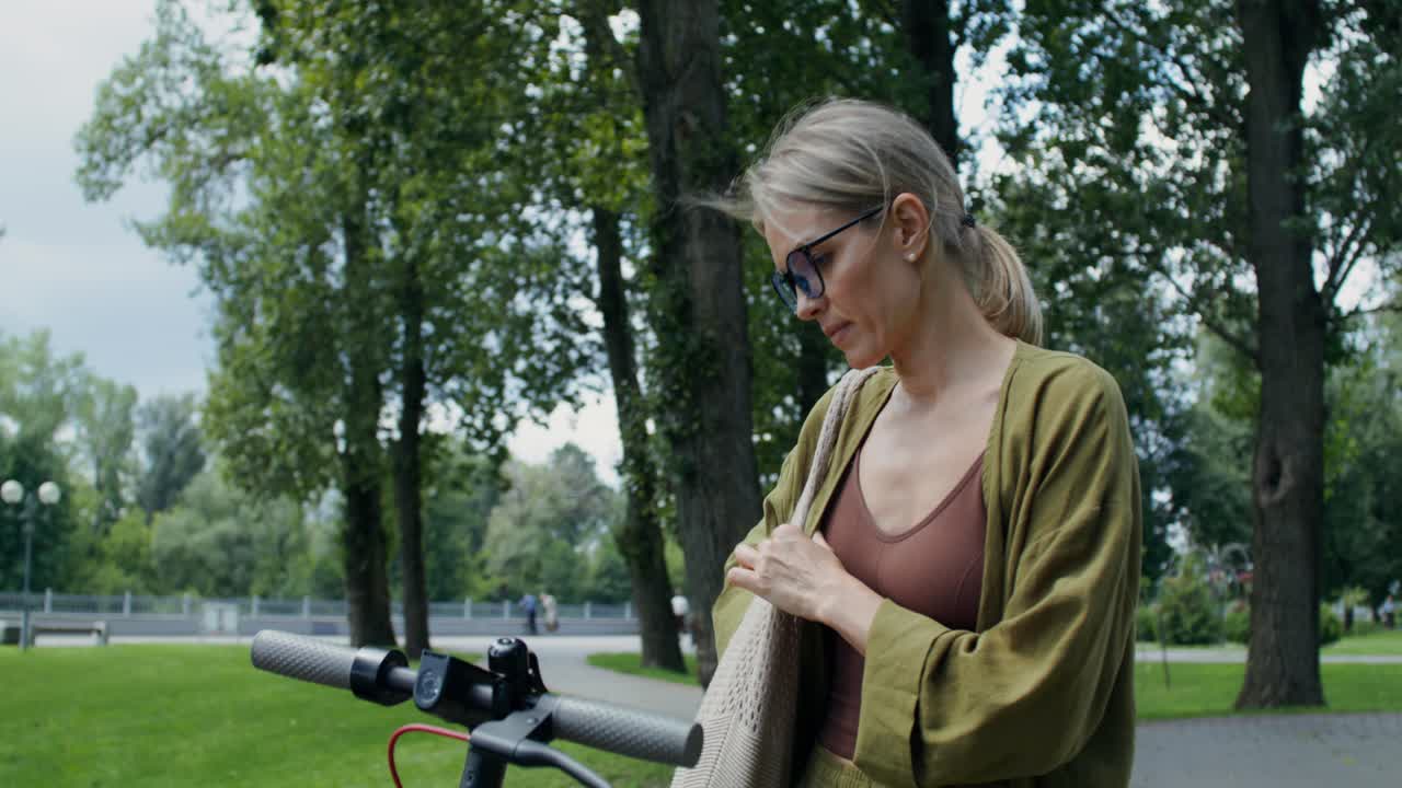 Woman using an electric scooter in the park