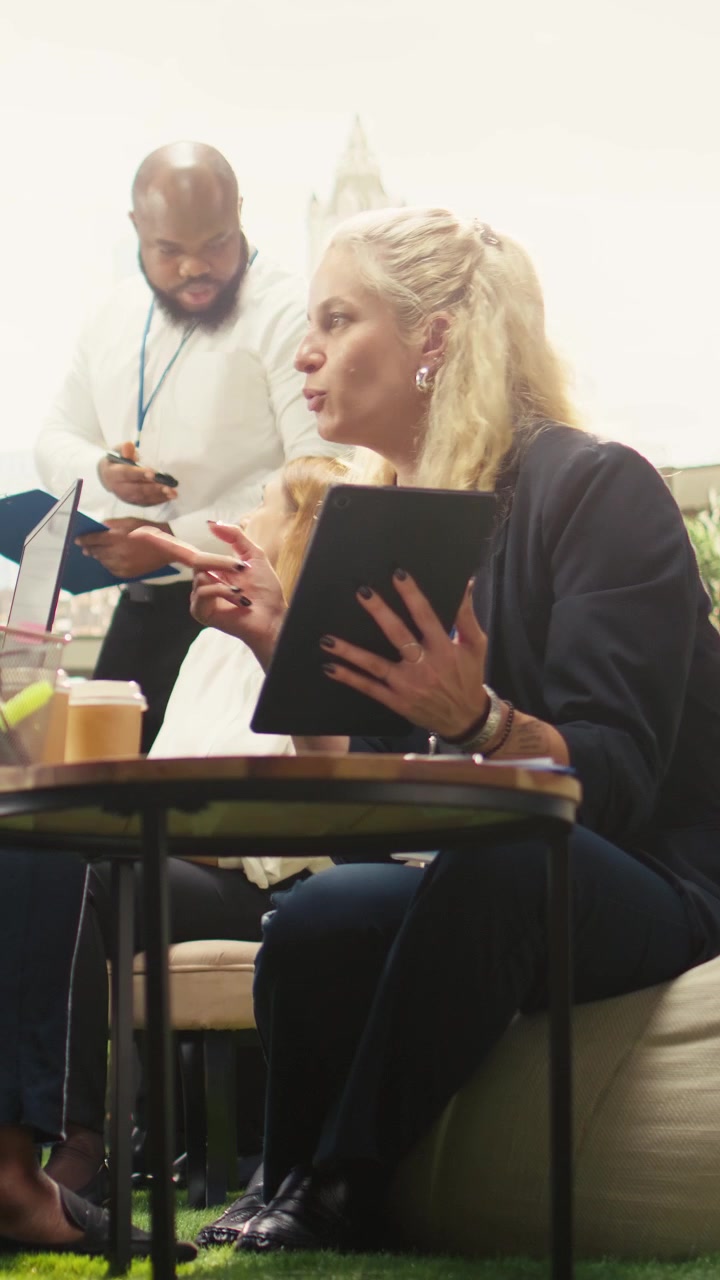 Vertikal video: Forskellige kolleger udveksler ideer i en uformel strategisession