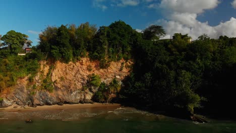 Waves-crashing-along-a-cliff-side-beach-in-a-fishing-village