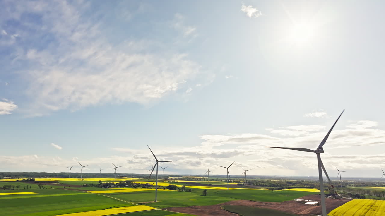 Beautiful renewable wind farm in Europe. Aerial tilt down
