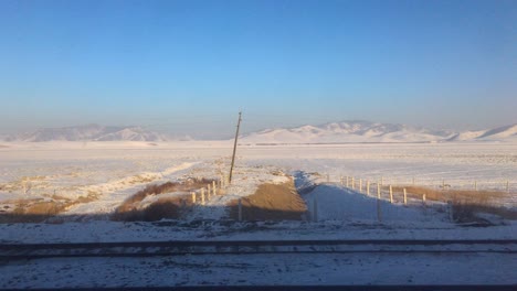 pov shot from trans-mongolian railway past scenic landscape during winter