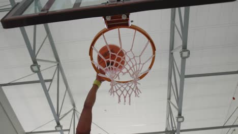 african american male basketball player scoring goal during match