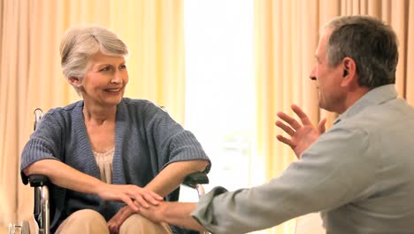 Woman-in-wheelchair-chatting-with-husband