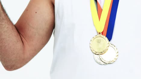 mid section of happy athlete with medals