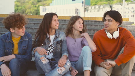 a group of four teenage friends of two girls and two boys have a funny conversation 1