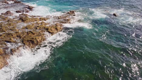 Ocean-waves-flowing-over-coastal-rocks-in-Canary-islands,-aerial-view