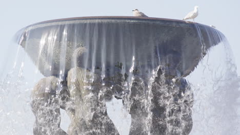 curtains of slow motion water flow from the great fountain in vigeland park oslo