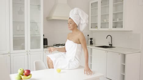 female wrapped in towel sitting on table