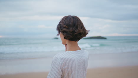 gorgeous brunette talking mobile phone closeup. beautiful girl walking beach