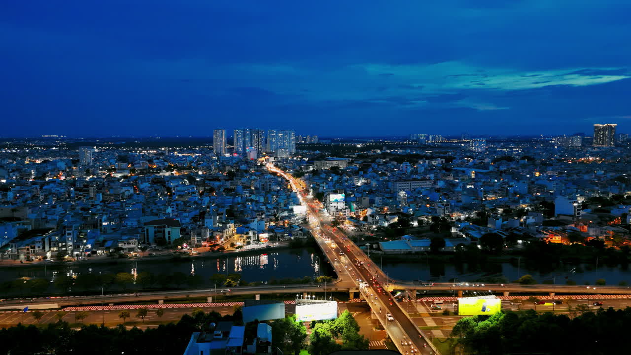 Experience the vibrant energy of Ho Chi City, also known as Saigon, as it lights up the night sky in this captivating aerial footage