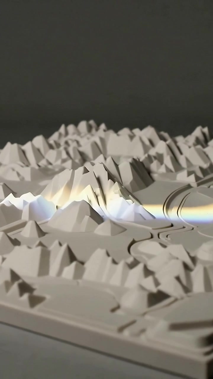 Vertical video: Rising light band sweeping white model on tabletop, camera panning, revealing seams