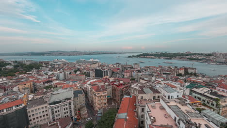 a panoramic view of istanbul's rooftops and the bosphorus from galata tower at sunset, timelapse