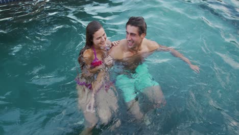 Happy-Caucasian-couple-enjoying-the-pool-during-a-sunny-day