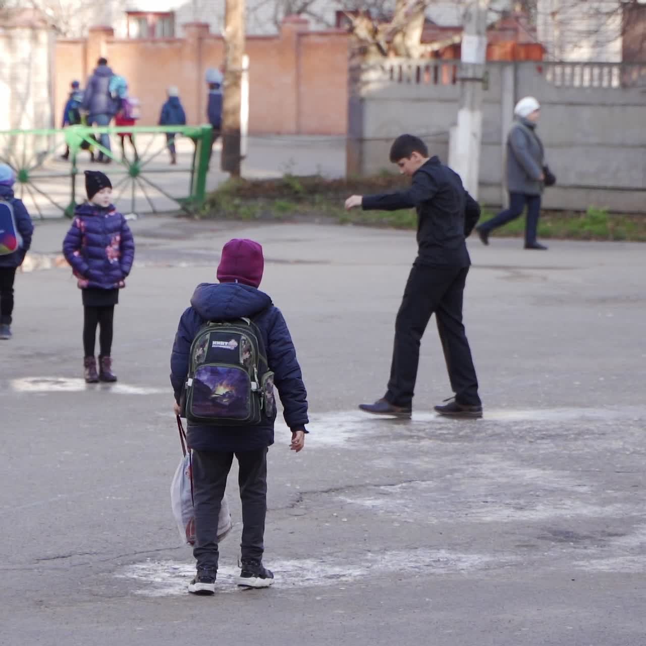 School friends. Happy school kids going home at end of day. Winter outdoor games