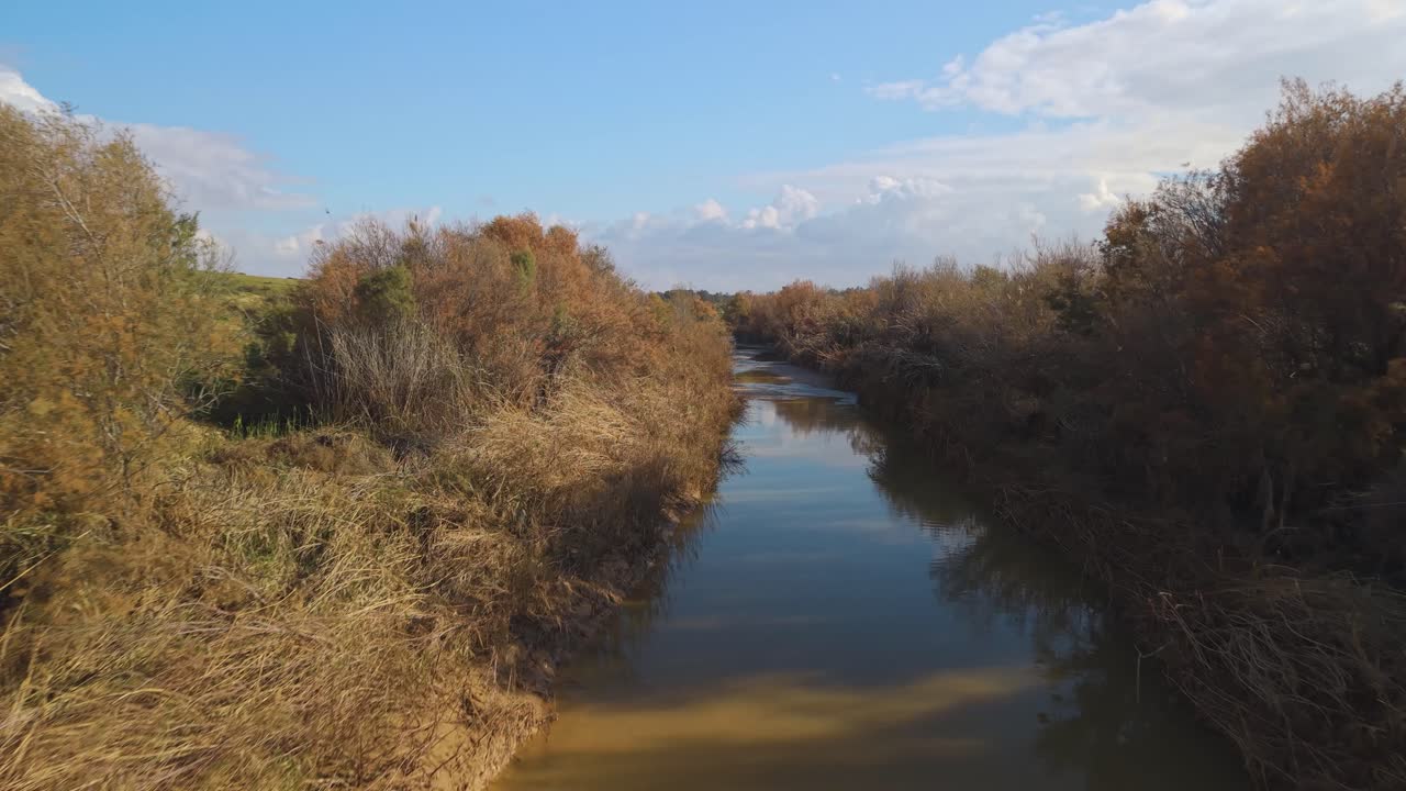 Besor Stream seasonal water flows through the desert riverbed during a clear winter day after rainfall