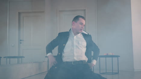 melodramatic dancer lies on ground enveloped in swirling smoke across studio floor, capturing intense emotional performance, fluid body movement, moody light, reflective mirror