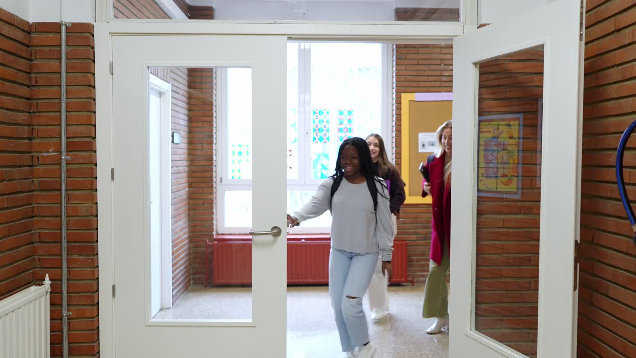 Group of students walking in a school hallway