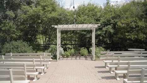 gorgeous outdoor wedding ceremony venue with wooden pews and a pergola on the forest edge of the property at the strathmere wedding and event centre