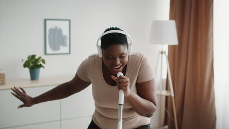 woman singing and dancing at home