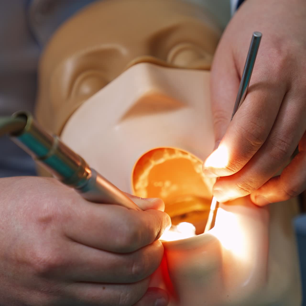 Praticando odontologia em um modelo. Mãos de um estudante segurando as ferramentas médicas. Close-up