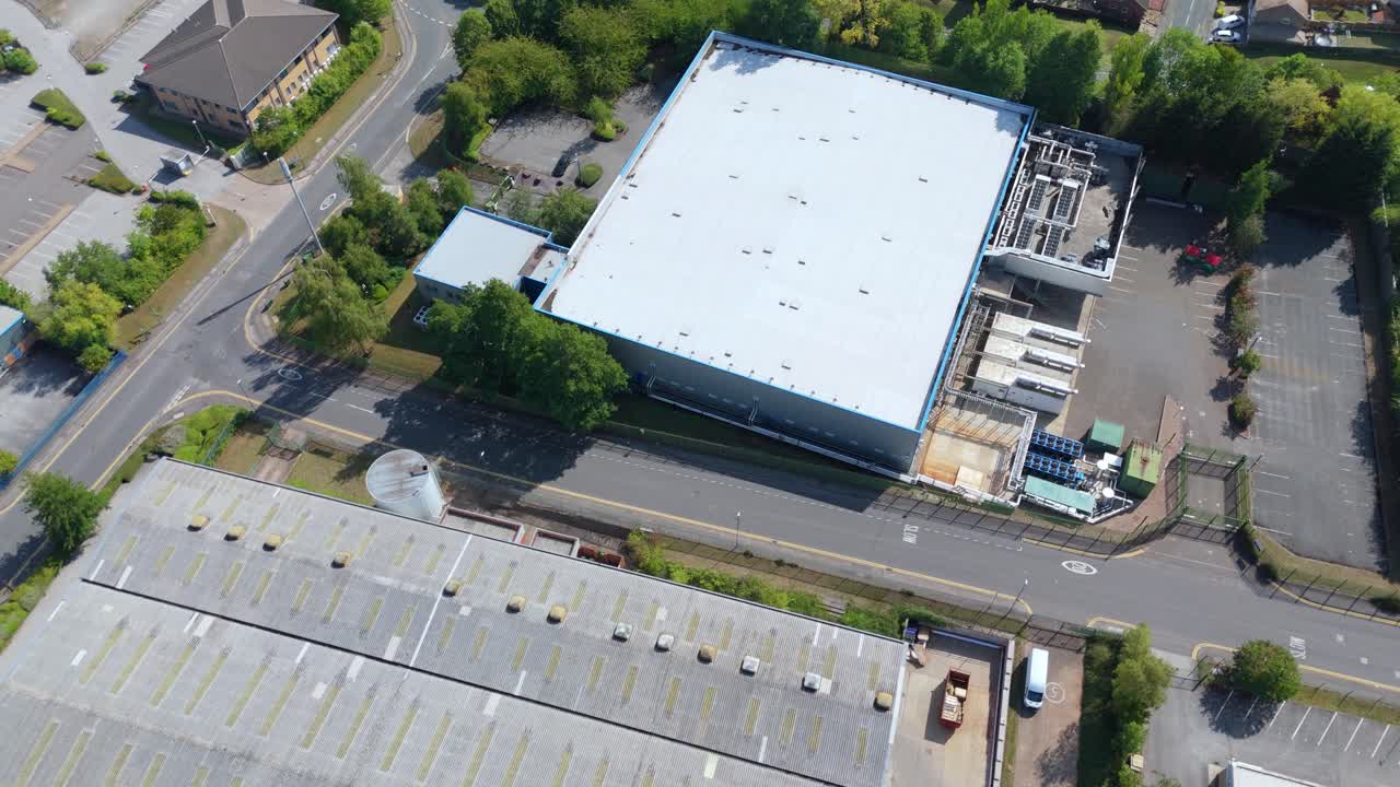 Cinematic aerial drone orbit of large data centre with IT infrastructure, cooling systems and cloud storage facilities Nottingham England UK
