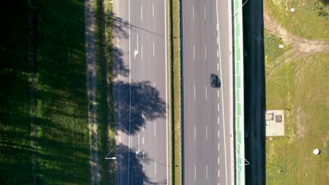 aerial top down shot of cars on highway in suburb area of gdynia during sunny day