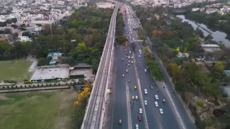 4k drone shots of a sunset in an indian city new delhi above trees and houses beautiful light punjabi bagh club posh colony metro train