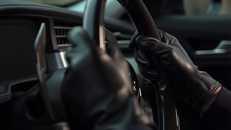 close-up of gloved hands on steering wheel