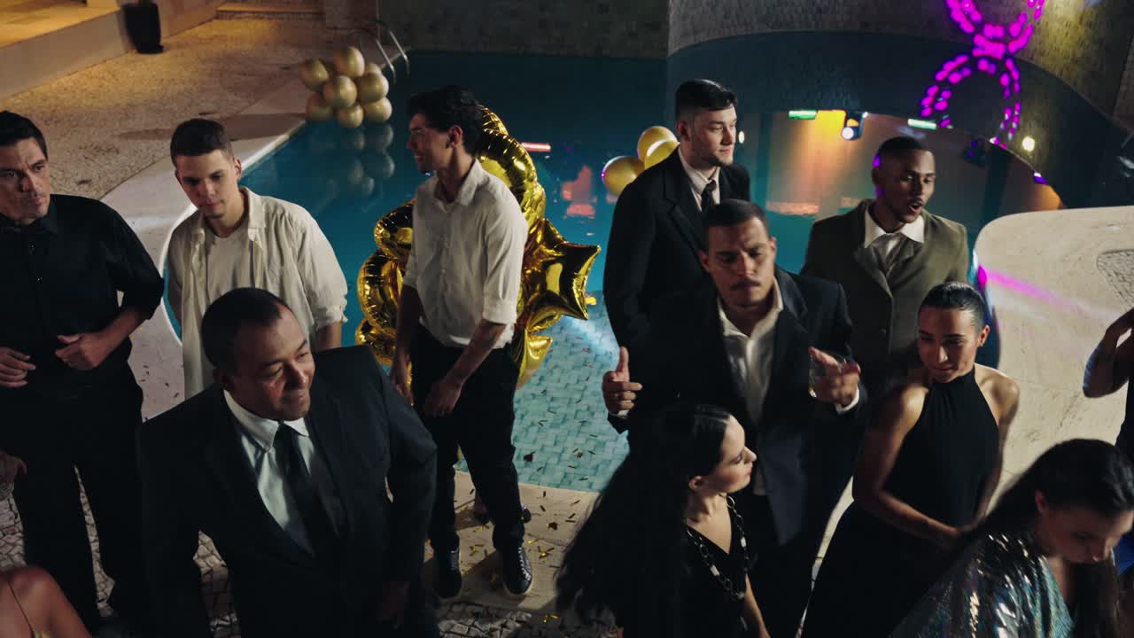 People celebrating and dancing at an elegant night pool party