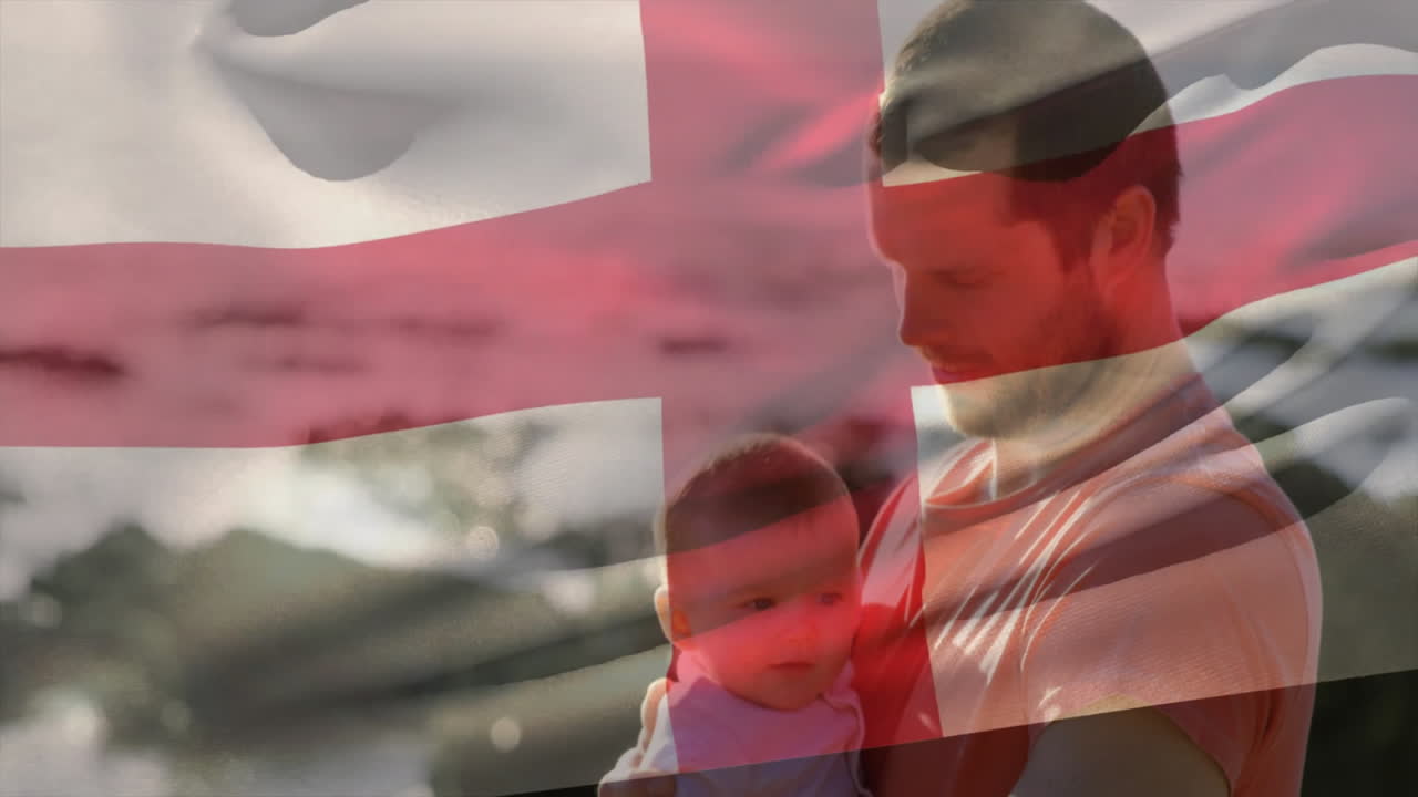 Holding baby with Danish flag animation overlay, man standing outside in park