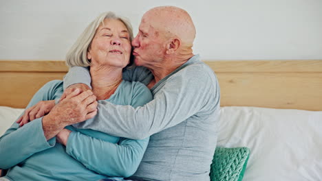 Senior-couple,-hug-and-kiss-in-bedroom