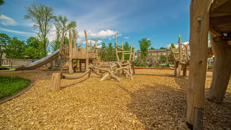 Static-shot-of-a-wooden-play-equipment-in-an-outdoor-playground-on-a-bright-sunny-day-in-timelapse