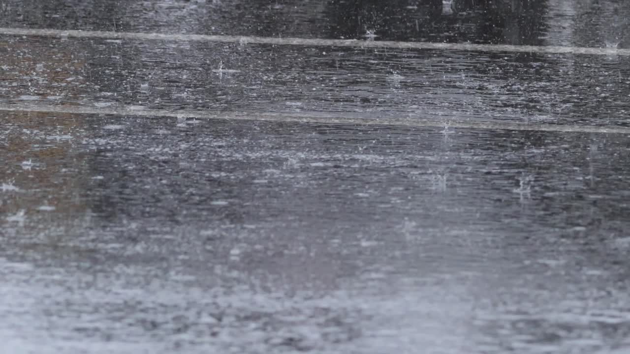 Heavy rain falling on a wet surface