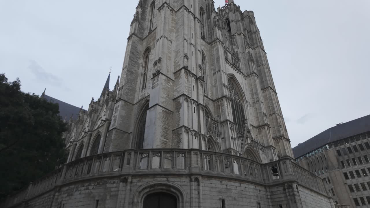 Low angle view of the impressive gothic architecture of St Michael and St Gudula Cathedral in Brussels, Belgium, under a cloudy sky
