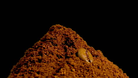 Cinematic-Coffee-Bean-Fall-Into-A-Pile-Of-Ground-Coffee-Slow-Motion