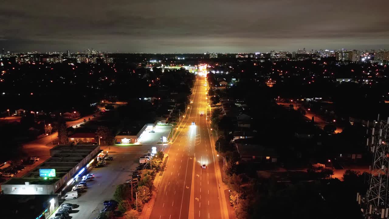 Drone hyperlapse of busy Toronto residential neighborhood street at night
