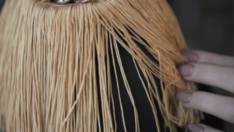 woman's handbag with tassels and chain detail