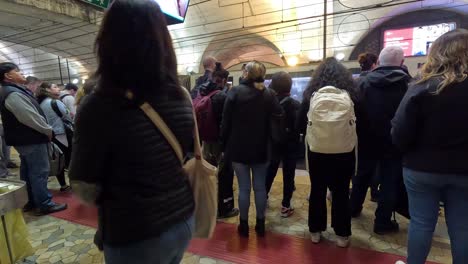 people gathered at a metro station in rome