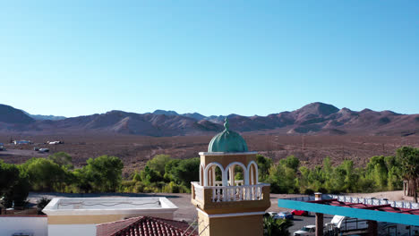 drone circles around a tower in a small town in the middle of desert