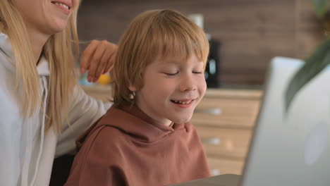 Little-Boy-And-Mother-Having-Fun-With-Laptop-At-Home