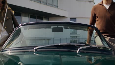 couple in a vintage convertible car