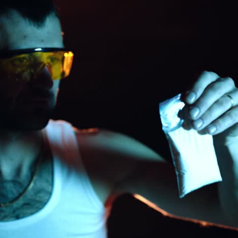 a gangster is examining the quality of the white powder in the basement. close-up. illegal narcotics production. drug trafficking